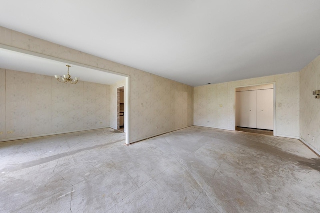 1S055 Spring Rd Unit 2B, Oakbrook Terrace, IL 60181 - empty room featuring a chandelier and unfinished concrete floors