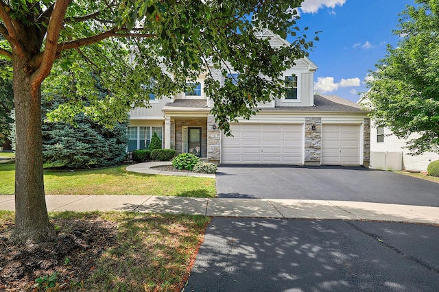 755 Rockhurst Rd, Bolingbrook, IL 60440 - view of front of home featuring stone siding, driveway, a garage, and a front yard