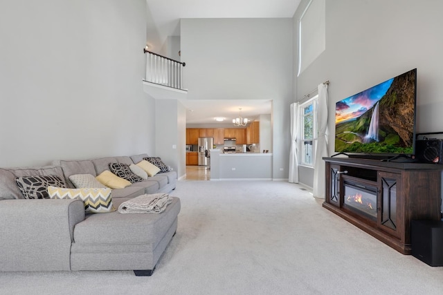 755 Rockhurst Rd, Bolingbrook, IL 60440 - living room with a chandelier, a high ceiling, light colored carpet, and a glass covered fireplace