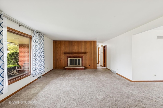 452 Miller St, Beecher, IL 60401 - unfurnished living room with carpet floors, baseboards, wood walls, and a brick fireplace