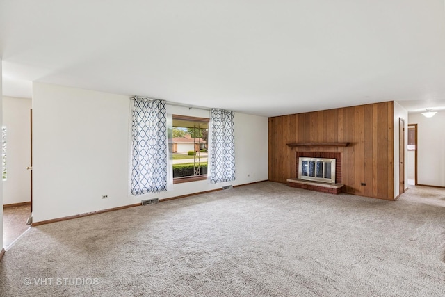 452 Miller St, Beecher, IL 60401 - unfurnished living room with carpet flooring, a fireplace, baseboards, and wood walls