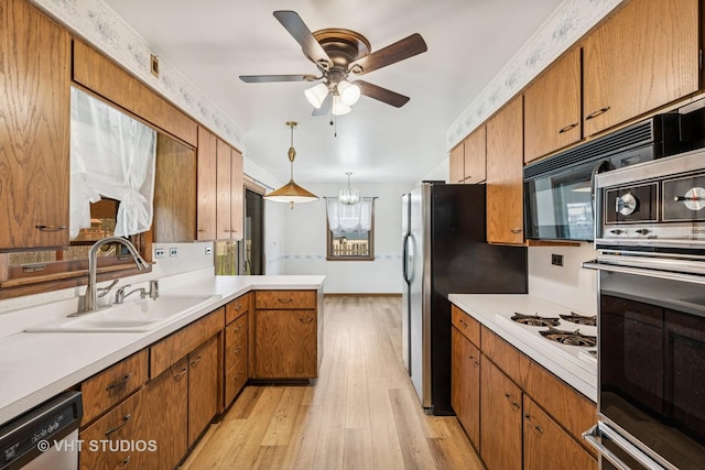 452 Miller St, Beecher, IL 60401 - kitchen featuring a sink, stainless steel oven, dishwasher, light wood-style flooring, and light countertops