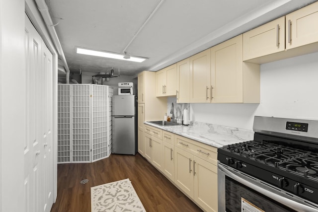 3907 New Haven Ave, Arlington Heights, IL 60004 - kitchen with stainless steel appliances, a sink, cream cabinetry, dark wood-style floors, and light stone countertops