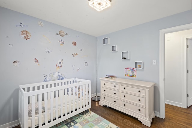 3907 New Haven Ave, Arlington Heights, IL 60004 - bedroom featuring dark wood-style floors, a crib, and baseboards