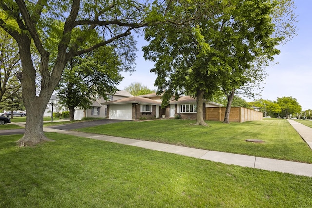 3907 New Haven Ave, Arlington Heights, IL 60004 - view of front of house featuring asphalt driveway, a front lawn, a garage, and brick siding