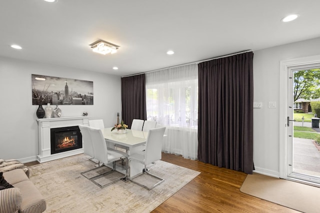 3907 New Haven Ave, Arlington Heights, IL 60004 - dining area featuring recessed lighting, wood finished floors, a glass covered fireplace, and baseboards