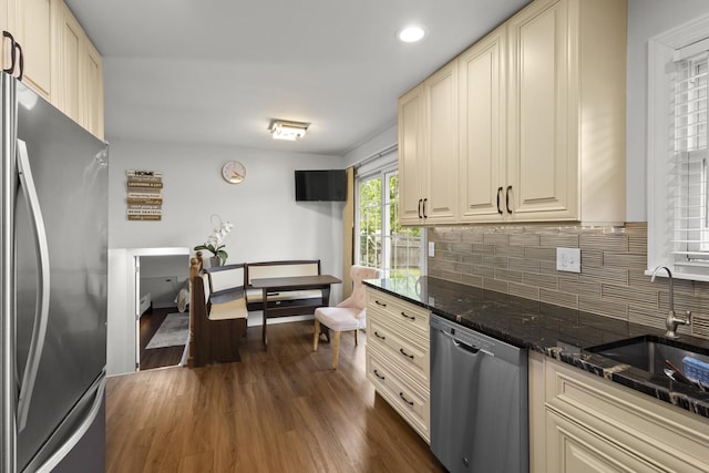 3907 New Haven Ave, Arlington Heights, IL 60004 - kitchen with appliances with stainless steel finishes, a sink, cream cabinetry, backsplash, and dark wood-type flooring