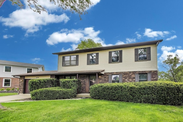 1976 Monday Dr, Elgin, IL 60123 - traditional-style house with an attached garage, brick siding, a front yard, and driveway