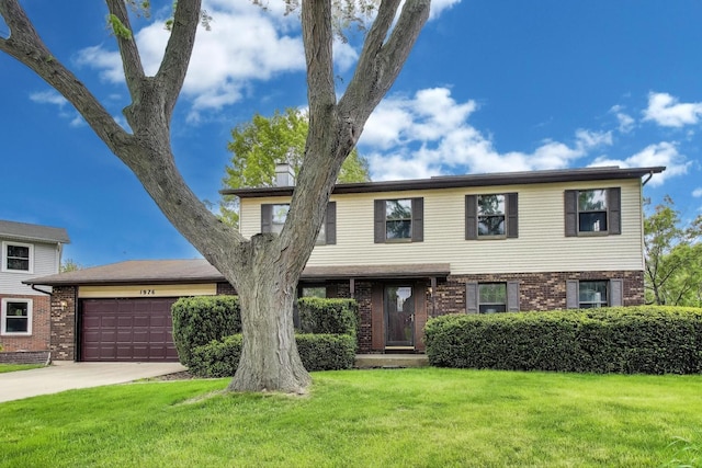 1976 Monday Dr, Elgin, IL 60123 - view of front of house with an attached garage, driveway, a front yard, and brick siding