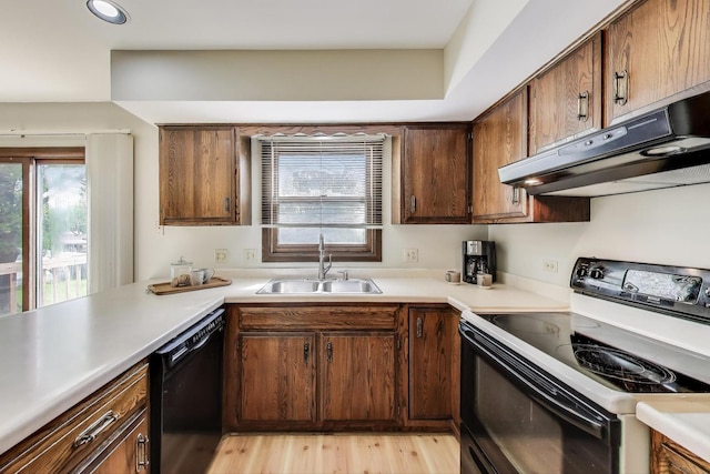 1976 Monday Dr, Elgin, IL 60123 - kitchen featuring range with electric stovetop, a sink, under cabinet range hood, black dishwasher, and healthy amount of natural light