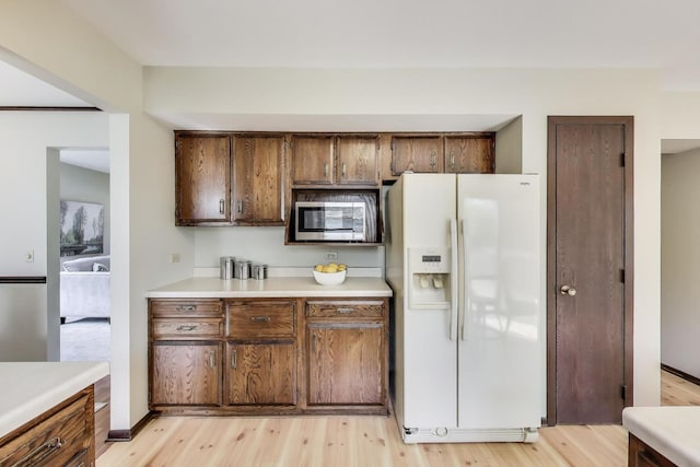 1976 Monday Dr, Elgin, IL 60123 - kitchen featuring white fridge with ice dispenser, stainless steel microwave, light countertops, and light wood-type flooring