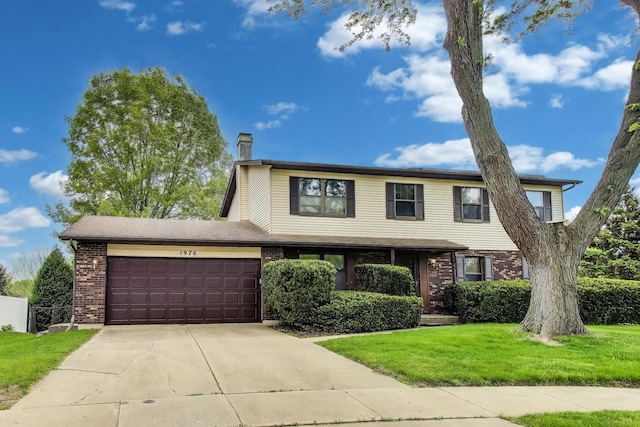 1976 Monday Dr, Elgin, IL 60123 - view of front of house with a garage, a chimney, brick siding, a front yard, and driveway