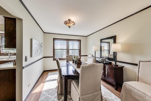 1976 Monday Dr, Elgin, IL 60123 - dining area with light wood finished floors, crown molding, and baseboards
