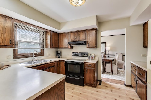 1976 Monday Dr, Elgin, IL 60123 - kitchen featuring electric stove, under cabinet range hood, a sink, light wood-type flooring, and light countertops