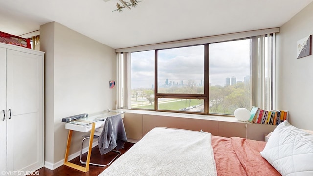 bedroom with dark wood-style flooring