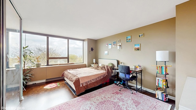 bedroom featuring baseboards and wood finished floors
