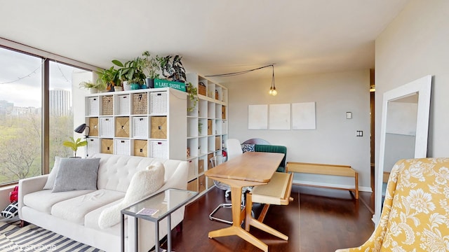 living area with wood finished floors and baseboards