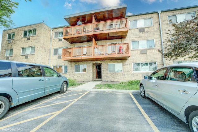 view of apartment building / complex featuring uncovered parking