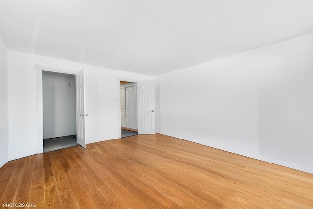 unfurnished room with wood finished floors
