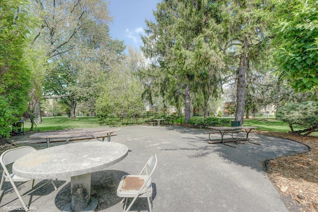view of patio / terrace featuring view of wooded area