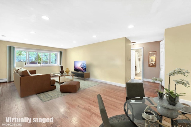 living room with wood finished floors, baseboards, recessed lighting, and baseboard heating