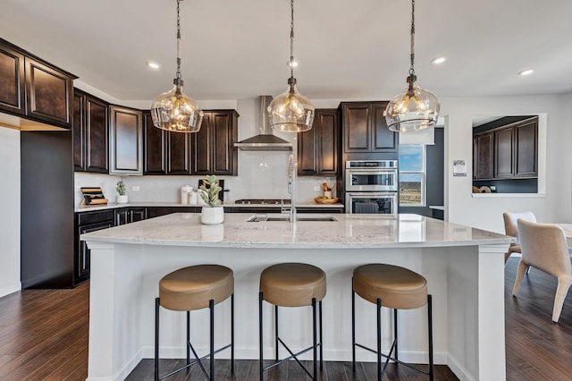 1995 Norwich Ln, Bolingbrook, IL 60490 - kitchen with wall chimney exhaust hood, double oven, recessed lighting, dark wood-style flooring, and dark brown cabinetry