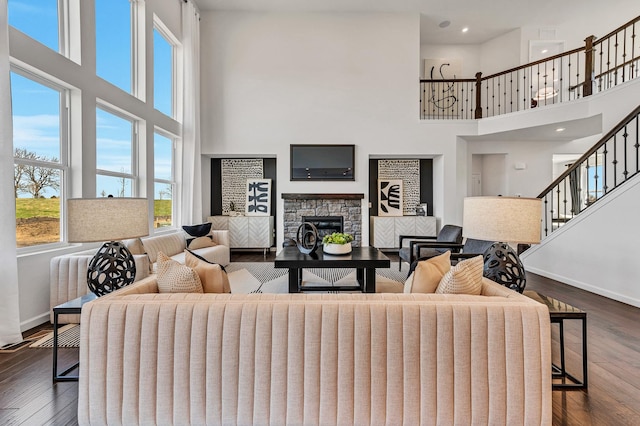 1995 Norwich Ln, Bolingbrook, IL 60490 - living area with a high ceiling, baseboards, a stone fireplace, dark wood-style flooring, and stairway