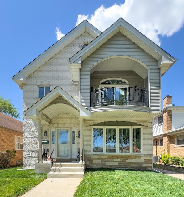 8024 N Odell Ave, Niles, IL 60714 - view of front facade with a balcony, brick siding, cooling unit, and a front lawn