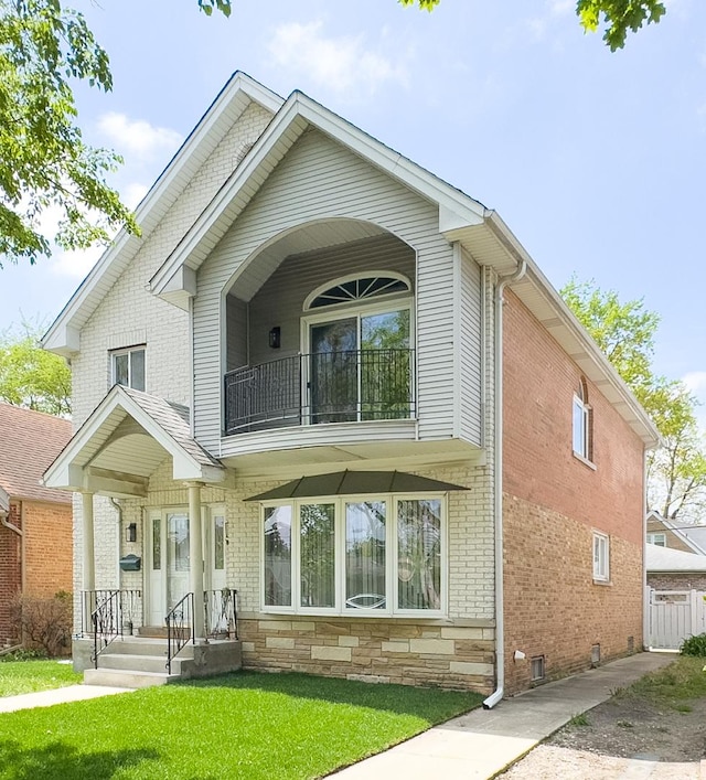 8024 N Odell Ave, Niles, IL 60714 - view of front of house with a balcony, a front yard, and brick siding