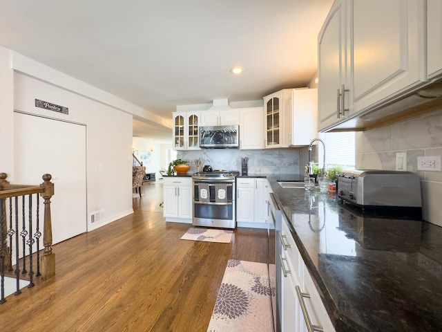 8024 N Odell Ave, Niles, IL 60714 - kitchen with appliances with stainless steel finishes, a sink, dark wood-style flooring, glass insert cabinets, and white cabinetry