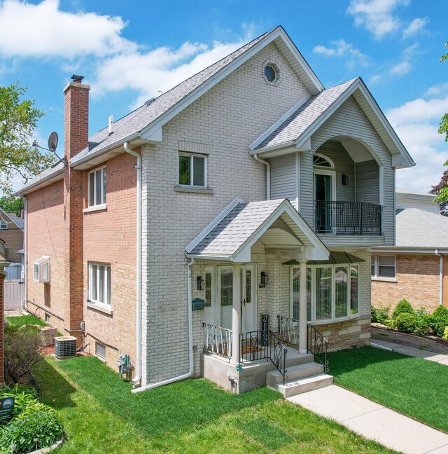 8024 N Odell Ave, Niles, IL 60714 - multi unit property with a balcony, brick siding, a front yard, a chimney, and a shingled roof