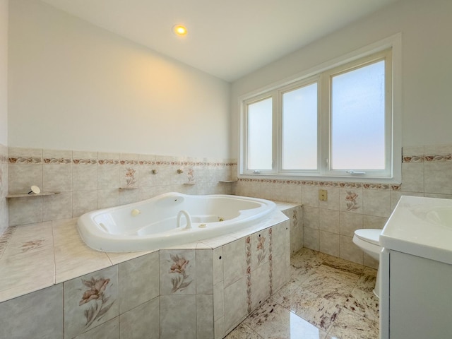 8024 N Odell Ave, Niles, IL 60714 - bathroom with a whirlpool tub, vanity, toilet, tile walls, and a wainscoted wall