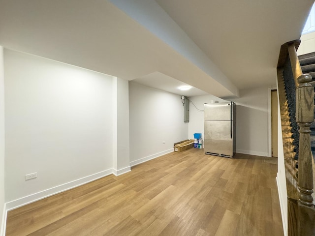 8024 N Odell Ave, Niles, IL 60714 - finished basement featuring freestanding refrigerator, light wood finished floors, and baseboards