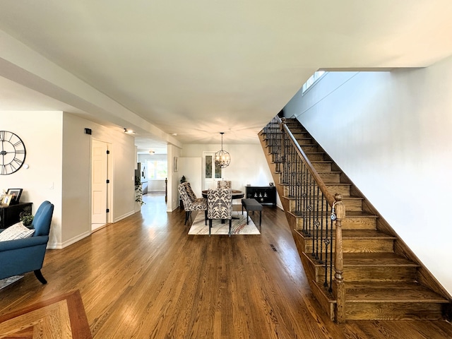 8024 N Odell Ave, Niles, IL 60714 - dining room with stairway, a chandelier, dark wood-style floors, and baseboards