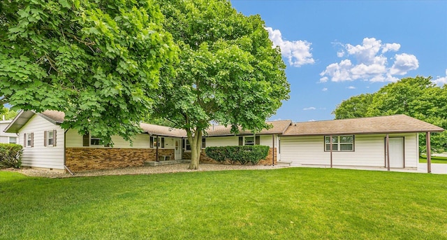 2908 Rolling Acres Dr, Champaign, IL 61822 - rear view of property featuring a yard and brick siding