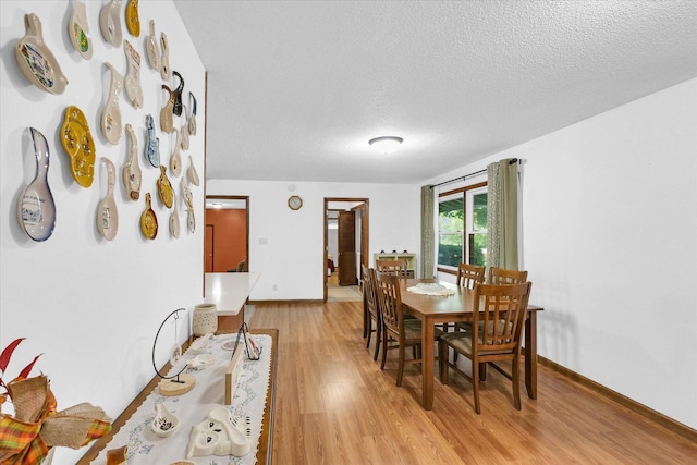 2908 Rolling Acres Dr, Champaign, IL 61822 - dining room with light wood-style floors and a textured ceiling