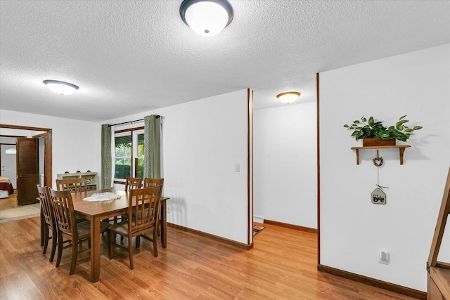 2908 Rolling Acres Dr, Champaign, IL 61822 - dining room with light wood finished floors and a textured ceiling