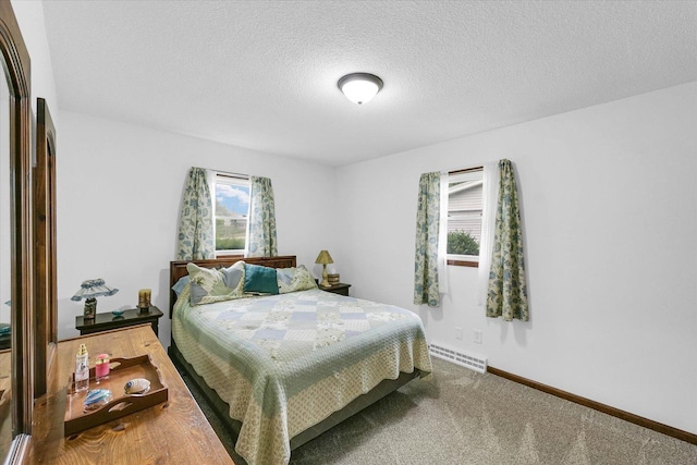 2908 Rolling Acres Dr, Champaign, IL 61822 - carpeted bedroom with a textured ceiling and a baseboard radiator
