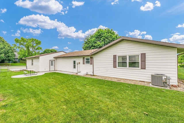 2908 Rolling Acres Dr, Champaign, IL 61822 - back of house with a patio and a lawn