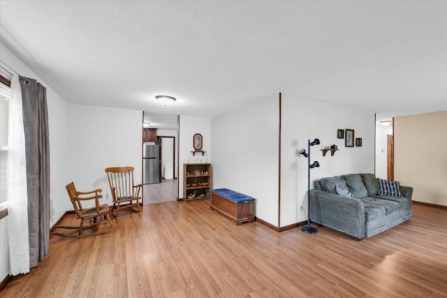 2908 Rolling Acres Dr, Champaign, IL 61822 - living room with light wood-style flooring and a textured ceiling