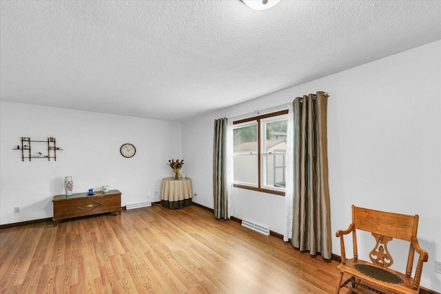 2908 Rolling Acres Dr, Champaign, IL 61822 - living area featuring light wood-style flooring and a textured ceiling