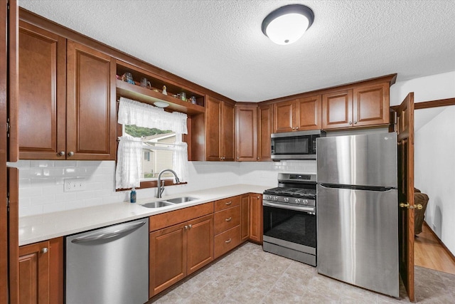 2908 Rolling Acres Dr, Champaign, IL 61822 - kitchen with stainless steel appliances, decorative backsplash, light countertops, a textured ceiling, and brown cabinetry