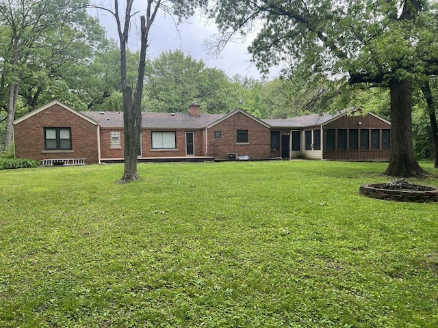 12200 S 88th Ave, Palos Park, IL 60464 - view of front of home with a sunroom, brick siding, a chimney, and a front yard