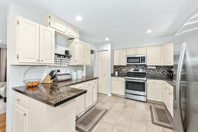 1613 Swallow St, Naperville, IL 60565 - kitchen with appliances with stainless steel finishes, dark countertops, a peninsula, and recessed lighting