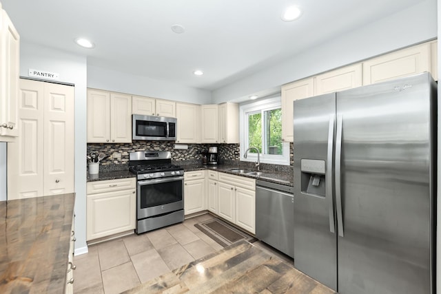 1613 Swallow St, Naperville, IL 60565 - kitchen featuring appliances with stainless steel finishes, a sink, tasteful backsplash, light tile patterned floors, and recessed lighting