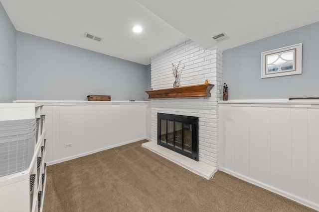 1613 Swallow St, Naperville, IL 60565 - unfurnished living room with carpet flooring, a fireplace, wainscoting, and a decorative wall