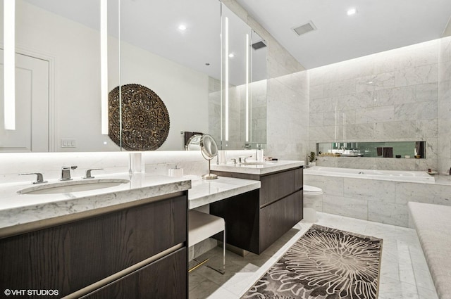 363 E Wacker Dr Unit 1601, Chicago, IL 60601 - bathroom with vaulted ceiling, a bath, marble tiled floors, vanity, and recessed lighting