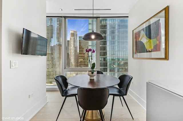 363 E Wacker Dr Unit 1601, Chicago, IL 60601 - dining room featuring baseboards, plenty of natural light, and a wall of windows
