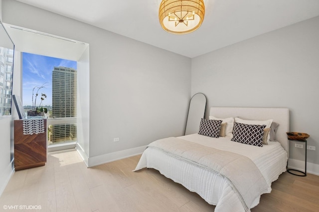 363 E Wacker Dr Unit 1601, Chicago, IL 60601 - bedroom featuring wood finished floors, baseboards, and a chandelier
