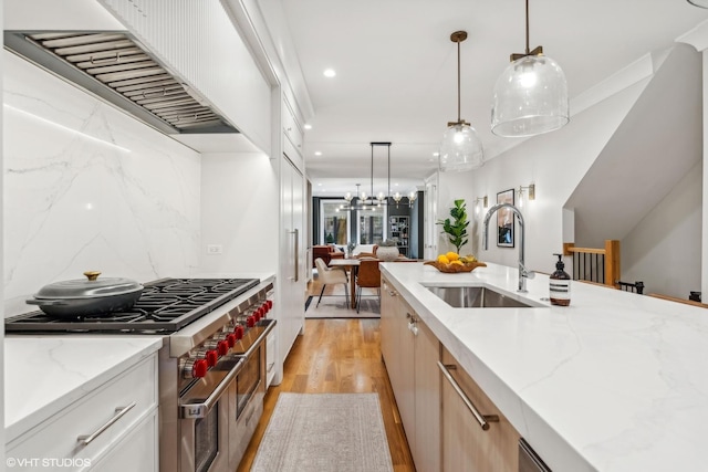 2034 N Mohawk St Unit 1, Chicago, IL 60614 - kitchen featuring a sink, double oven range, wall chimney exhaust hood, light wood-style flooring, and recessed lighting